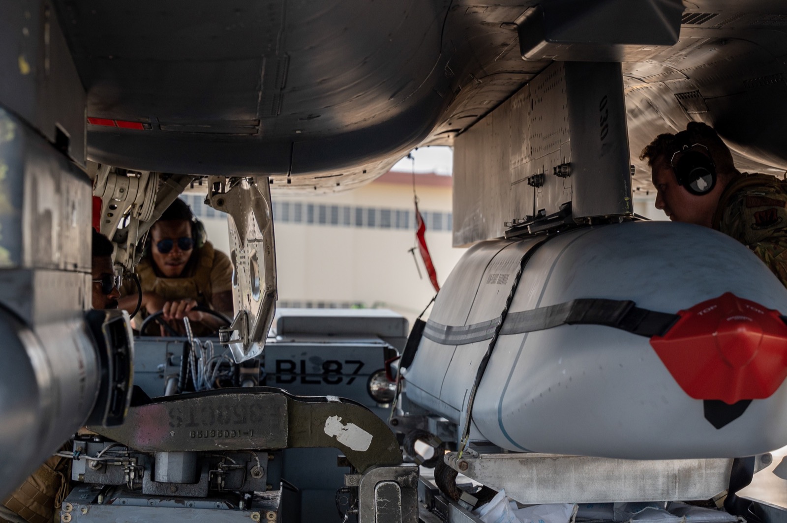 Weapons specialists working beneath an F-15E